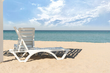 travel vacation concept, chaise lounge armchair on the summer sandy beach