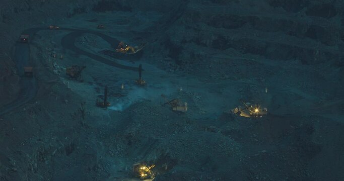 Timelapse video of mining and large equipment in an iron ore quarry. Open-pit mining in the morning twilight