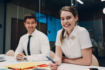 Businessman and businesswoman team at office meeting. Business people group conference discussion sit at table with boss man and woman