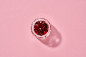 Krill oil softgels in a glass jar - source of omega 3 fatty acids