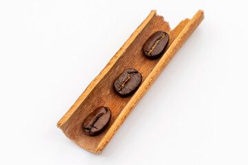 Three beans of coffee in a cinnamon stick