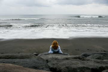 Woman on the black sand beach