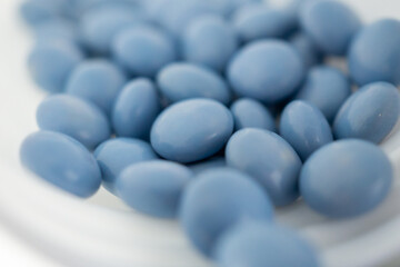 blue medicine pills with bottle on white background