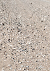Gravel road background. Old pebble rock countryside road during summer. Empty copy space.