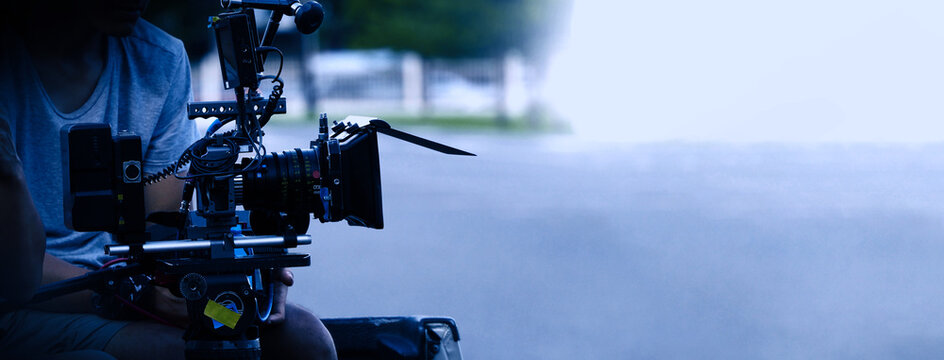 Video production behind the scenes. Making of TV commercial movie that film crew team lightman and cameraman working together with film director in studio. film production concept. Silhouette style.