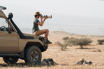 Traveling photographer taking photos during safari