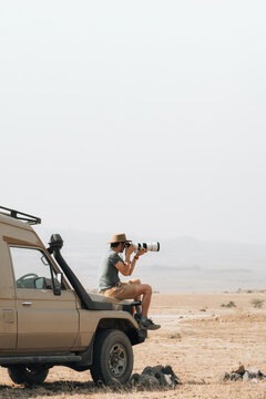 Traveling photographer taking photos during safari