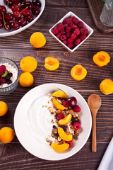 cottage cheese and yougurt with granola, berries and fruits apricot for healthy breakfast.