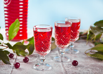 glasses of cherry brandy liqueur with ripe berries
