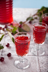 glasses of cherry brandy liqueur with ripe berries