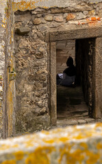 Young Friar seated at the door of a meditation room, inside the Insua Fortress in Caminha, Portugal.