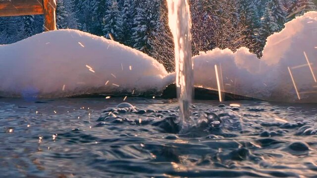 Snow covered holy spring with metal bowl and wooden house with plunge font pool for ablutions, gazebo for relaxing in a natural park in sunny winter day.
Nature park Stone Hill in the Mari El