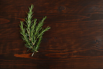 Fresh rosemary bound on brown  wooden board. Healthy organic concept. Aroma herb for cooking