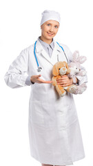 female doctor in a white coat and hat. a medic holds soft toys, a hare and a bear and smiles. the pediatrician held out her hand, points to the toys. white background isolated