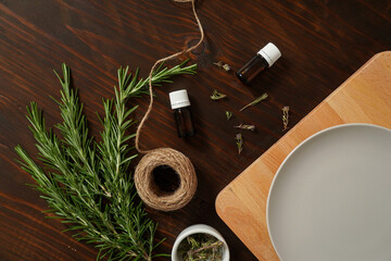 Fototapeta na wymiar Fresh rosemary bound on brown wooden board with twine and dry thyme flowers. Healthy organic concept. Aroma herb for cooking