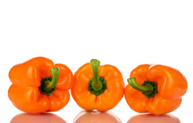 Three organic bell peppers, close-up, isolated on white.