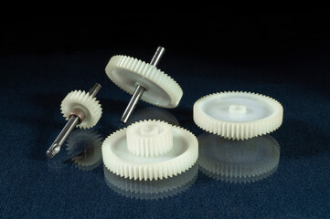 White plastic gear on the table with reflection