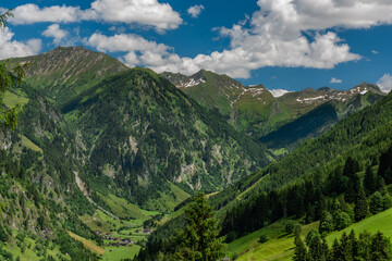 Naklejka na ściany i meble Summer valley with Grossarler Ache small river and blue cloudy sky