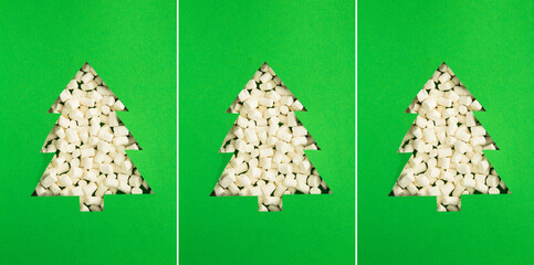 Christmas collage. Christmas tree cut out on the green background and filled with marshmallows. Close-up.