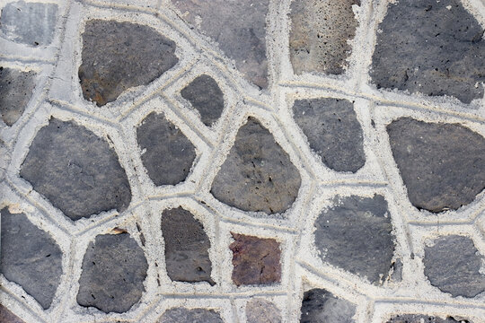 a dark wall made of angular stones