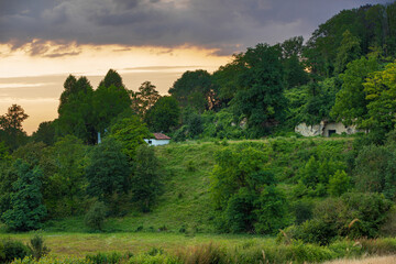 View on a hill with a wholes from a former quarry during a sunset.