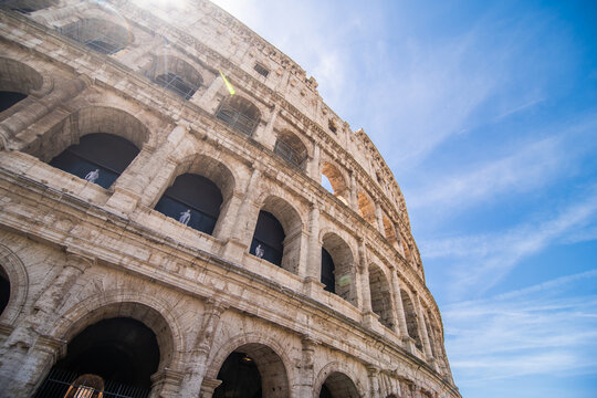Rome, Italy - Juny, 2021: Ancient Roman Colosseum is one of main tourist attractions in Europe. People visit the famous Colosseum in Roma city center. Scenic nice view of Colosseum ruins in summer.