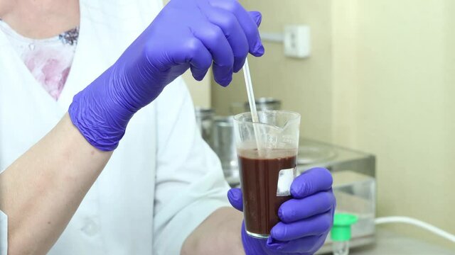 the laboratory assistant checks the products of the food factory for composition and quality