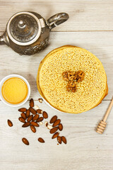 Moroccan or Algerian pancakes named Baghrir in arabic with honey syrup decorated with walnuts and almond