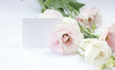 Fototapeta na wymiar Bouquet of eustoma with a card for signature/ Bouquet of eustoma. Eustoma flowers isolated on white background