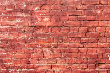 Texture of a brick wall with cracks and scratches which can be used as a background