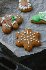 Obraz na płótnie Canvas christmas gingerbread cookies on a baking tray. Snowflake, gingerbread man. 