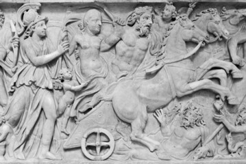 Black and white photo of ancient roman battle scene engraved on a marble wall