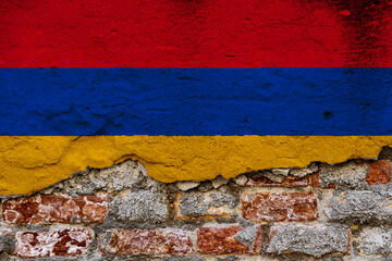 Graphic Concept with a Flag of Armenia painted on a damaged brick wall.