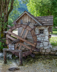 Wooden water wheel mill. Park and landscape design.