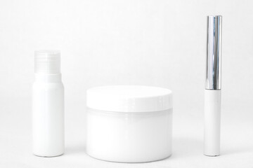 Fototapeta na wymiar cosmetic flat lay: face cosmetics in white on a white background 
