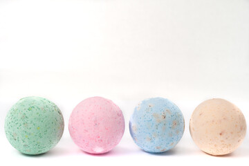 bathroom bombs green, pink, cream and blue on a white background