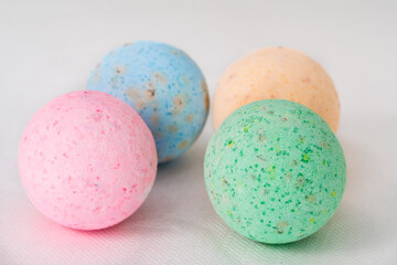 bathroom bombs green, pink, cream and blue on a white background