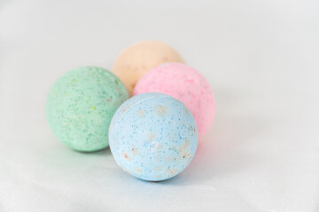 bathroom bombs green, pink, cream and blue on a white background