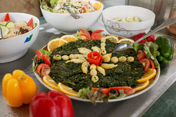 photo of a plate with stewed spinach on the buffet, Moroccan cuisine