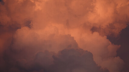 Masses of clouds hanging in the sky in red and white and crimson hues
