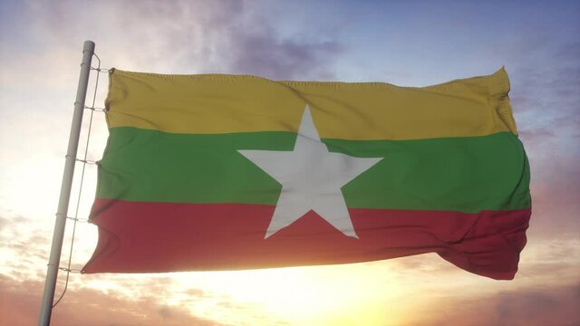 Flag of Myanmar waving in the wind, sky and sun background