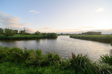 Summer landscape during sunset with the traditional dutch windmill the 't Hoog- en Groenland.