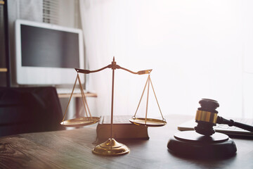 Business and lawyers discussing contract papers with brass scale on desk in office. Law, legal...