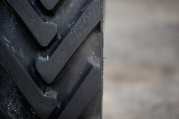 Close-up of a wheel of a tractor Belarus. Strong tread ridge on the wheel. Rural life. Copy space