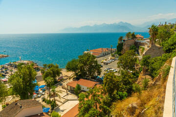 Fototapeta na wymiar ANTALYA, TURKEY: Top view of the old town, the sea and the mountains on a sunny summer day in Antalya.