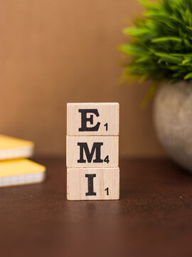 Assam, india - March 30, 2021 : Word EMI written on wooden cubes stock image.