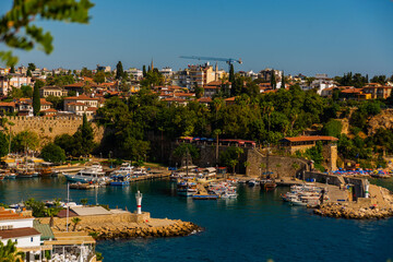 Fototapeta na wymiar ANTALYA, TURKEY: Top view of the old harbor and the pier for tourist boats and pirate ships in the port in Antalya.