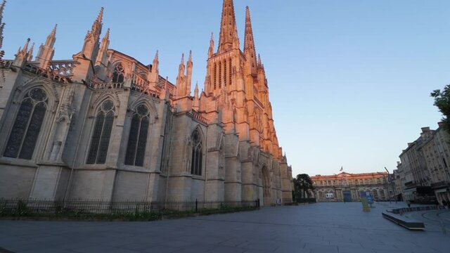 Saint andrew cathedral side wall and pey berland square empty during sunrise with nobody, moving smooth wide shot