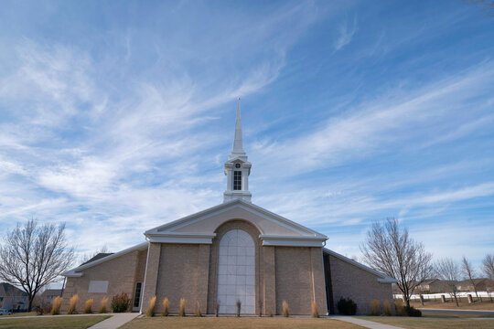 Facade Of A Church In A Low Angle View With A Sky And Clouds Background