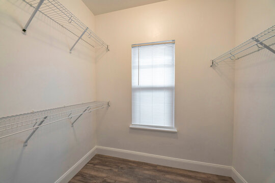 Small Empty Walk In Closet With Wall Mounted Steel Wire Shelves